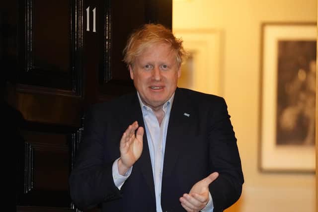 Prime Minister Boris Johnson clapping outside 11 Downing Street in London to salute local heroes during Thursday's nationwide Clap for Carers NHS