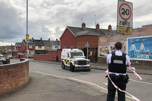 Police at the scene at Etna Drive in the Ardoyne area of Belfast, where a man has died following a shooting. A burnt-out car was reportedly found nearby