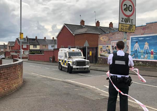 Police at the scene at Etna Drive in the Ardoyne area of Belfast, where a man has died following a shooting. A burnt-out car was reportedly found nearby
