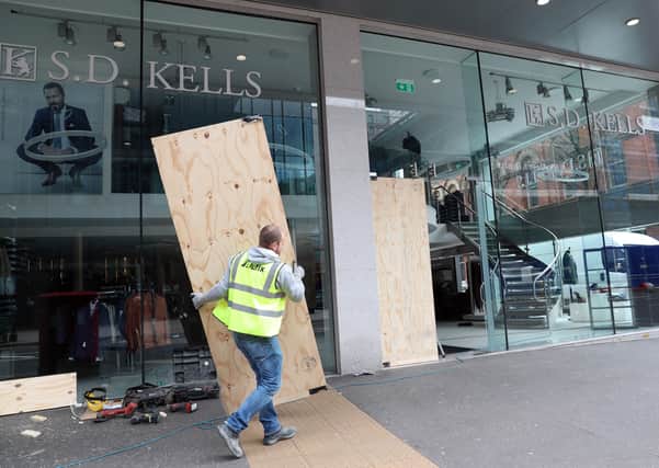 Workmen board up the entrance of SD Kells clothing shop in Bedford Street, Belfast after it was ram raided for the second night in a row by thieves using a stolen car.
 Picture Stephen Davison, Pacemaker