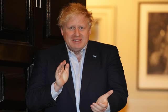 10 Downing Street handout photo of Prime Minister Boris Johnson clapping outside 11 Downing Street in London to salute local heroes during Thursday's nationwide Clap for Carers NHS initiative to applaud NHS workers fighting the coronavirus pandemic