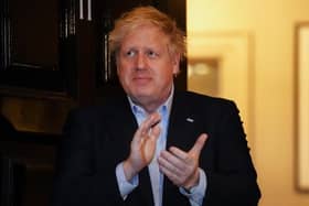 Prime Minister Boris Johnson clapping outside 11 Downing Street in London last week to salute local heroes.