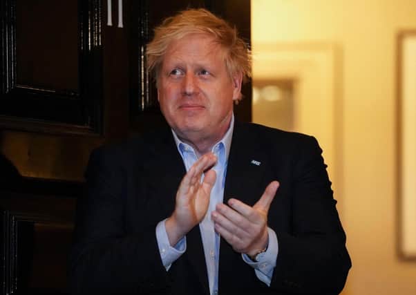 Prime Minister Boris Johnson clapping outside 11 Downing Street in London last week to salute local heroes.