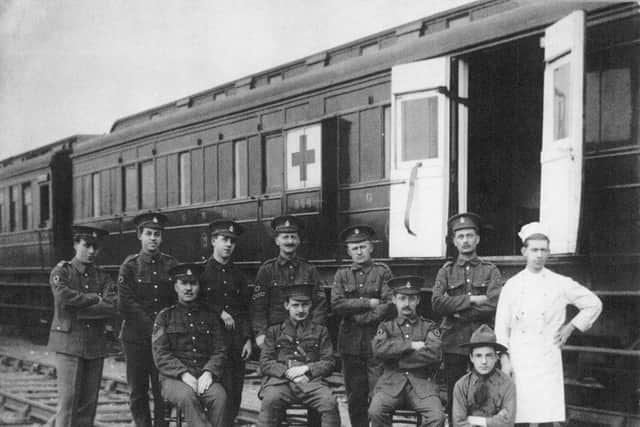 Belfast's number 13 ambulance train at Clones in 1915 with RAMC crew and local boy scout