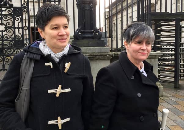 Shannon Sickles (left) and Grainne Close outside Belfast High Court after judgment was reserved in a landmark challenge to the ban on gay marriage in Northern Ireland. PRESS ASSOCIATION Photo. Picture date: Friday December 4, 2015. Two couples, Grainne Close and Shannon Sickles and Chris and Henry Flanagan-Kanem brought the case claiming the region's prohibition on same sex marriage breached their human rights. See PA story ULSTER Marriage. Photo credit should read: Lesley-Anne McKeown/PA Wire