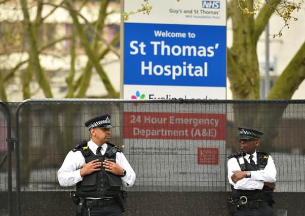 Police officers outside St Thomas' Hospital in Central London on Wednesday, where Prime Minister Boris Johnson remains in intensive care as his coronavirus symptoms persist.