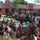 Women wait for emergency cash in Pakistan during lockdown. Death rates are said to be much higher without treatment, which is a huge problem for poor nations with bad healthcare