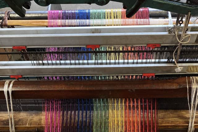 Rainbow material being woven on the loom