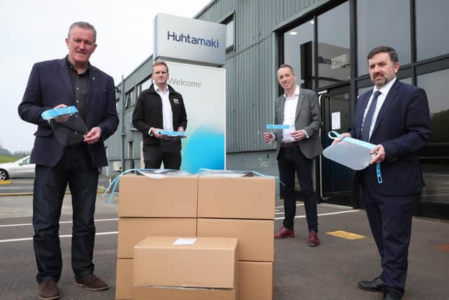 Ministers Robin Swann (right) and Conor Murphy (left) at the Huhtamaki factory in Belfast