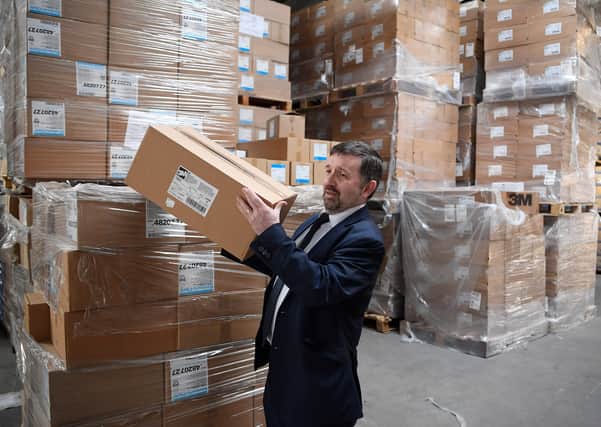 Minister Robin Swann visits a personal protection equipment (PPE) distribution centre as NHS deliveries began earlier this month. Picture: Michael Cooper