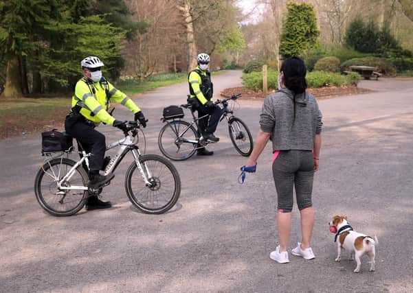 PSNI officers on bicycles talk to members of the public as they patrol Ormeau Park in Belfast on Good Friday. 
PICTURE BY STEPHEN DAVISON, PACEMAKER