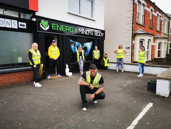 Aaron McGonigle pictured kneeing with members of his team says they will supply the elderly and vulnerable essential items "straight to the end."