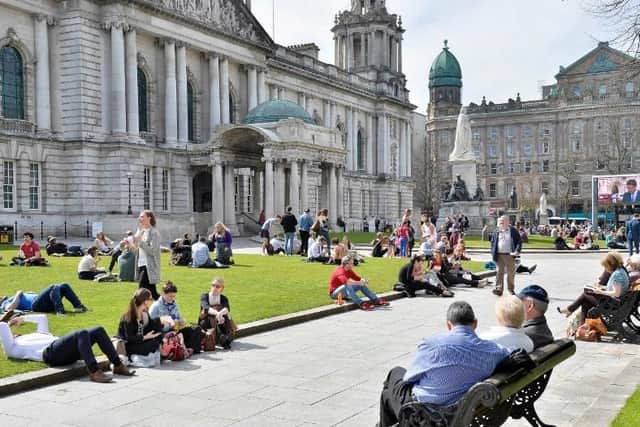 People enjoying the sunshine near Belfast City Hall in 2016 when social distancing was not a public health concern. (Photo: Presseye)