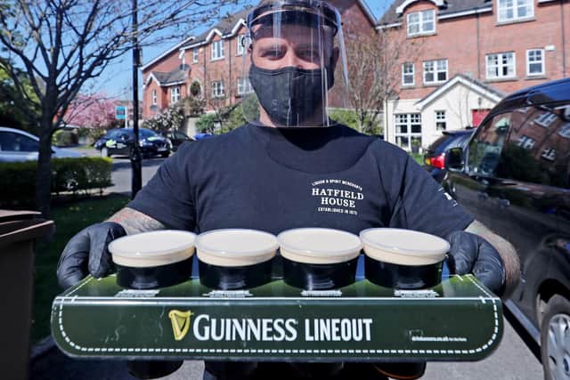 Barman Harry McKeaveney from the Hatfield bar delivery service delivers pints of draft Guinness around Belfast. (Photo: PA Wire)