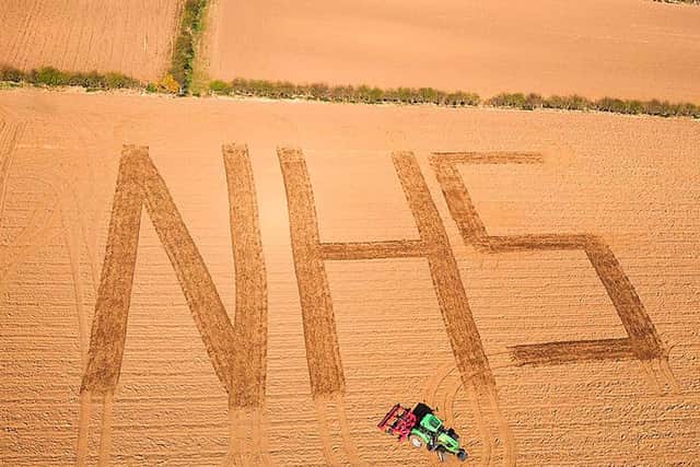 19/04/20.. McAuley Multimedia..Agricultural Machinery sales company Hunter Kane & Son displays a message of support for the NHS, the Ballintoy based company etched the support in a field at Kilmean Farm in Ballintoy over the weekend