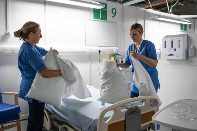 NHS nurses prepare a hospital bed for a patient who has tested positive for COVID-19. (Photo: PA Wire)