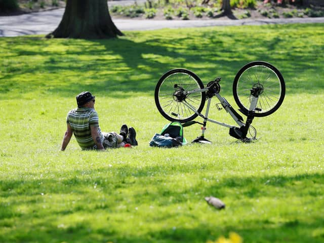 A cyclist takes a breather in the sunshine in Belfast's Botanic Gardens