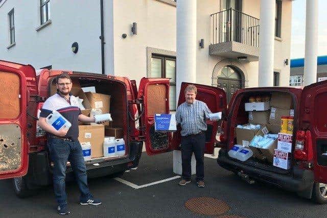 Deputy Grand Master Harold Henning and Brother Chris Wallace unload part of the PPE consignment at Kilkeel Orange Hall