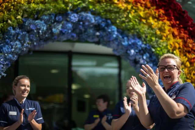 NHS nurses help to unveil a rainbow floral display outside the University College Hospital at Euston Road, in London to thank the public for their support during the ongoing coronavirus pandemic. PA Photo: Thursday April 23, 2020