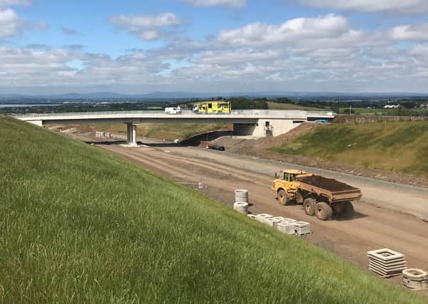 Work on a section of the Belfast-Londonderry A6 road, betwen Randalstown and Castledawson. "This scheme is costing the earth, quite literally," says Chris Murphy
