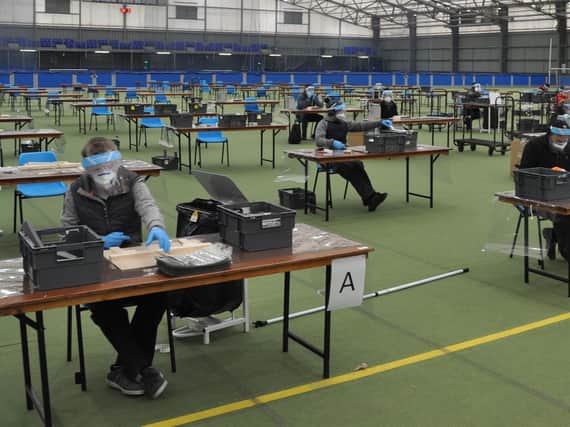 Busy producing face shields at their workstations in Meadowbank Sports Arena.
