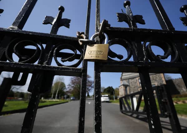 Locked gates at the City Cemetery on Belfast’s Falls Road, which like every other graveyard across Northern Ireland is banned from opening