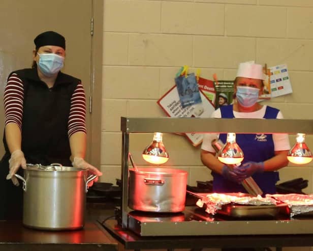 Barbara Pinkerton and Karen Spratt preparing hot meals to be delivered by Orange volunteers
