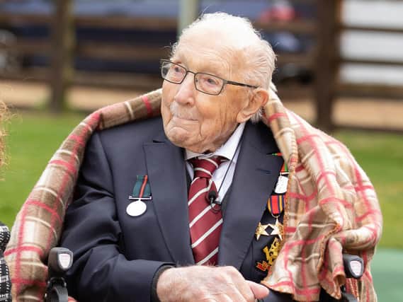 Second World War veteran Captain Tom Moore as he watches a Battle of Britain Memorial Flight flypast of a Spitfire and a Hurricane passing over his home as he celebrates his 100th birthday