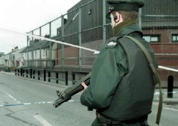 A police officer of the Royal Ulster Constabulary outside a heavily fortified RUC station during the Troubles