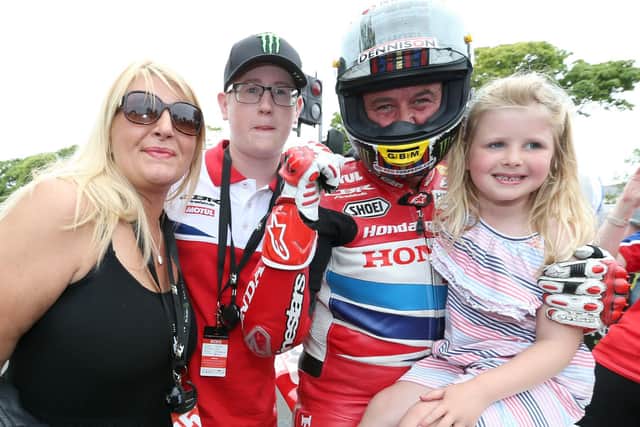 John McGuinness celebrates his 23rd Isle of Man TT victory in 2015 with his wife Becky, son Ewan and daughter Maisie Grace.