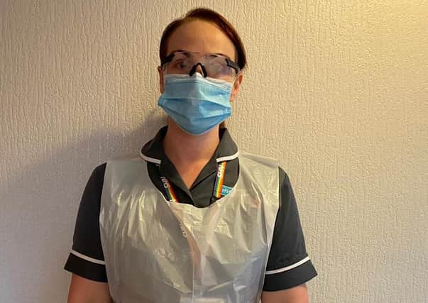 Sam Rutherford, 31, wearing personal protective equipment supplied to domiciliary carers in the South Eastern Trust