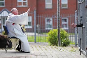 Father Paddy McCafferty takes outdoor confession at Corpus Christi in Ballymurphy, west Belfast, at the weekend