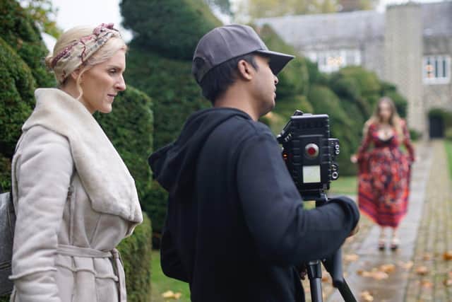 Loraa White, founder of Budget Music Videos, centre, filming on location