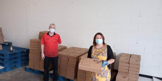 Councillor Michaela Boyle, receiving PPE equipment from Niall Diamond, Director, Diamond Corrugated