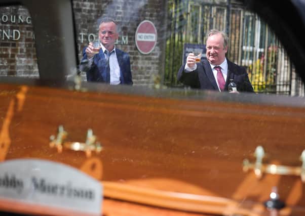 Hole in the Wall Gang actors Paddy Jenkins and Damon Quinn raised a toast to BJ Hogg as his remains entered Roselawn Cemetery yesterday. 

Photo: Kelvin Boyes / Press Eye.