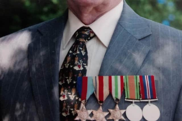 Dave Mullin proudly displays his WWII medals