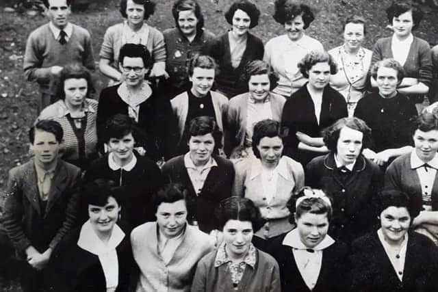 Pictured with work colleagues. Mary is second from the left in the front row.
