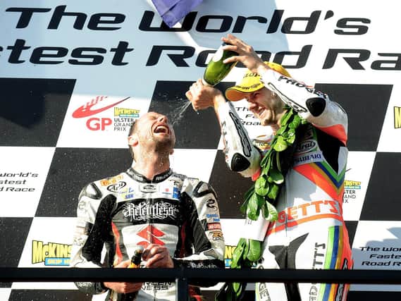 Bruce Anstey gets a soaking from Ian Hutchinson after winning the second Superbike race at the 2010 Ulster Grand Prix.
