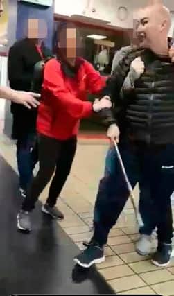 Footage which appears to show Shankill bomber Sean Kelly being restrained by others after an incident at a shopping centre