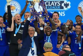 Leicester City captain Wes Morgan and manager Claudio Ranieri lift the trophy as the team celebrate winning the Barclays Premier League