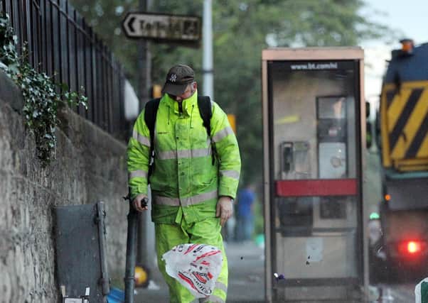 A council worker cleans the streets in south Belfast. Picture by Kelvin Boyes / Press Eye