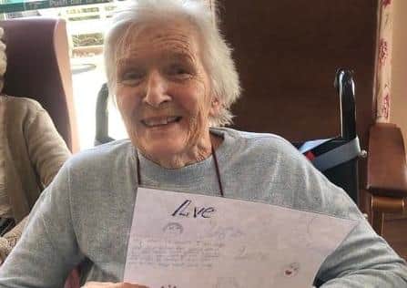 Resident Phyllis Brown enjoys a letter sent to Beechvale by a child