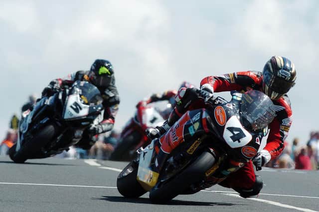 John McGuinness (HM Plant Honda) leads Bruce Anstey (Relentless Suzuki) in the opening Superbike race.