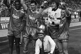Wimbledon manager Bobby Gould is crowned with the FA Cup in 1988 when he joined his victorious team on the turf at Wembley following their 1-0 win over Liverpool. Pic by PA.