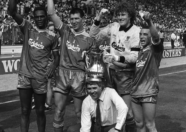 Wimbledon manager Bobby Gould is crowned with the FA Cup in 1988 when he joined his victorious team on the turf at Wembley following their 1-0 win over Liverpool. Pic by PA.