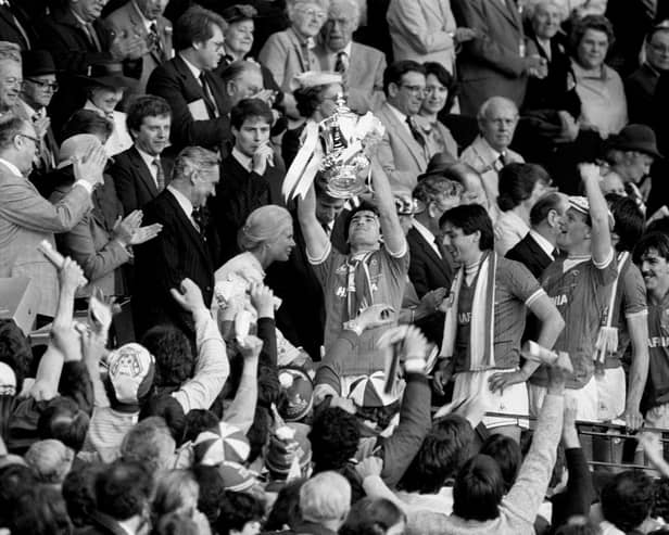 Kevin Ratcliffe, holds the trophy aloft after Everton's 2-0 victory over Watford
