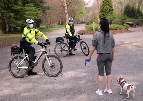 PSNI officers on bicycles talk to members of the public as they patrol Ormeau Park in Belfast - enforcing social distancing regulations - on Good Friday. 
Picture: Stephen DAvison/Pacemaker