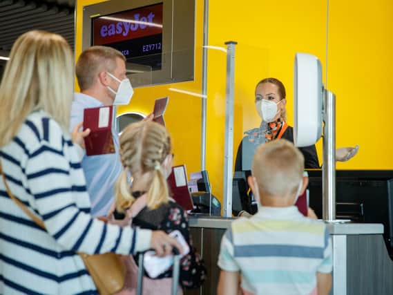 Photo issued by EasyJet of new bio security measures taking place at an EasyJet checkout counter, as the low-cost carrier is to resume flights from a number of UK airports from June 15