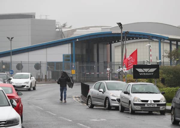 A worker walks towards the Wrightbus plant in Ballymena. Photo credit: Niall Carson/PA Wire