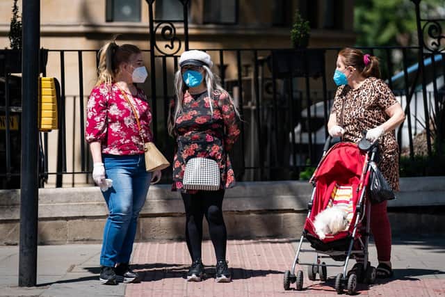 Three women wearing protective masks out for a walk during the Coronavirus pandemic. (Photo: PA Wire)
